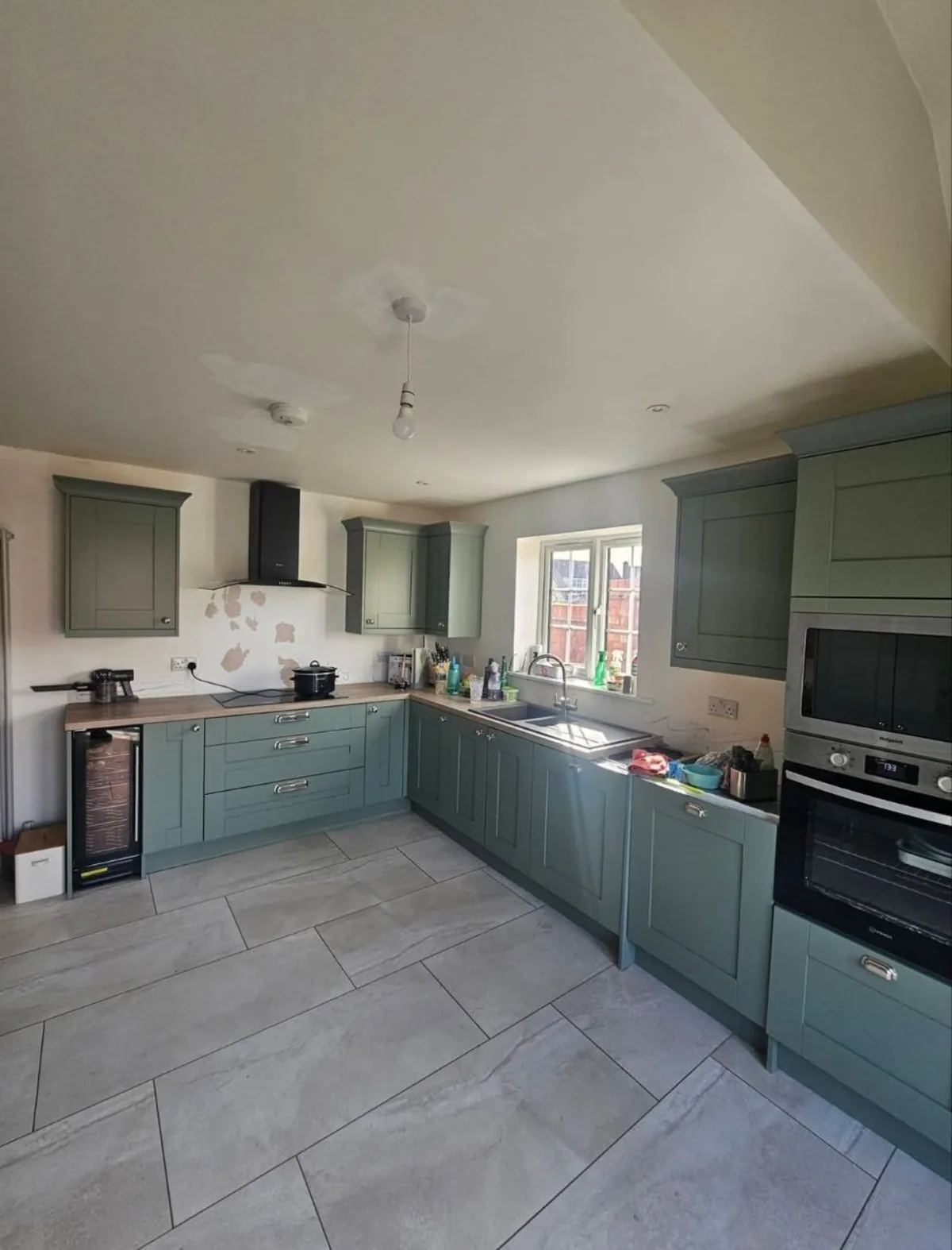 Sage green shaker kitchen with wooden worktops